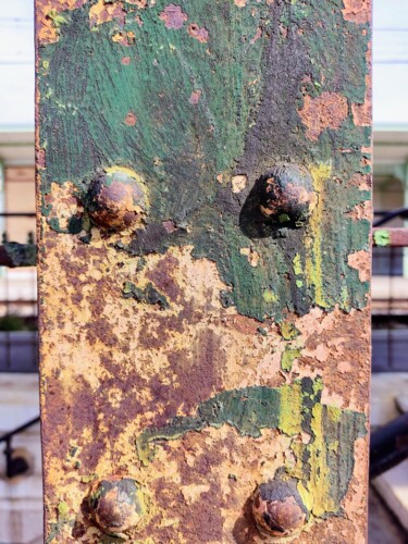 Greens and ochres of a train station pillar